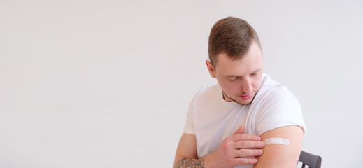 Caucasian Man smiling after receiving covid-19 vaccination.