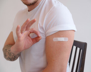 Caucasian Man smiling after receiving covid-19 vaccination.