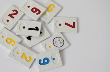 Rummy pieces randomly mixed on a white background. Free space for text. Rummy society boardgame