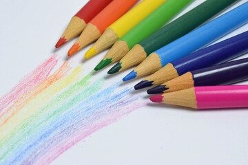 Colored pencils with a rainbow hand drawing