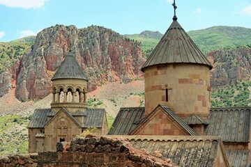 Fototapeta na wymiar Noravank is a 13th-century monastery near the city of Yeghegnadzor, Armenia, located in a narrow gorge of the Amaghu River. The gorge is known for its height and for the steep brick red walls 