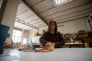 Spanish woman working at a hand fan design workshop