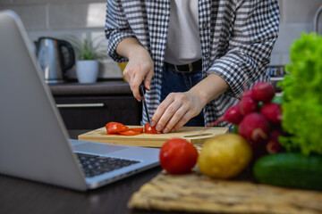 woman cutting tomatoes on the board home kitchen