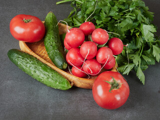 Raw fresh vegetables background. Healthy food flat lay on wooden background. Assortment of organic red and green vegetables: tomato, radish, broccoli, aubergine, cucumber, rucola, red onion