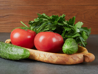 Raw fresh vegetables background. Healthy food flat lay on wooden background. Assortment of organic red and green vegetables: tomato, radish, broccoli, aubergine, cucumber, rucola, red onion