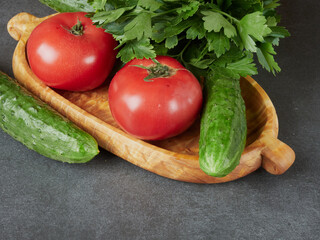 Raw fresh vegetables background. Healthy food flat lay on wooden background. Assortment of organic red and green vegetables: tomato, radish, broccoli, aubergine, cucumber, rucola, red onion