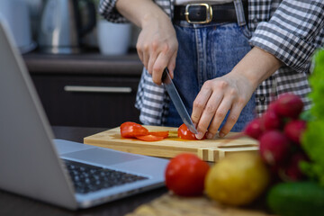 woman cutting tomatoes on the board home kitchen