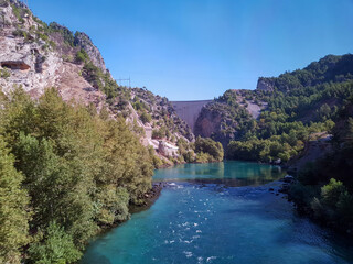 Seascape against the backdrop of mountains on a cloudless sunny day.