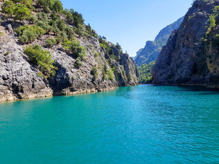 Seascape against the backdrop of mountains on a cloudless sunny day.