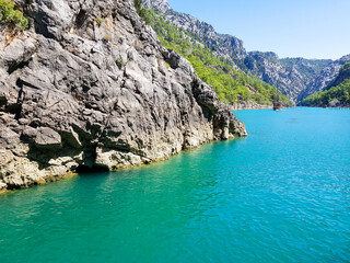 Seascape against the backdrop of mountains on a cloudless sunny day.