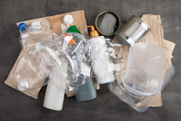 Recycling and ecology concept. Sorting household waste - plastic, paper, metal, captured from...