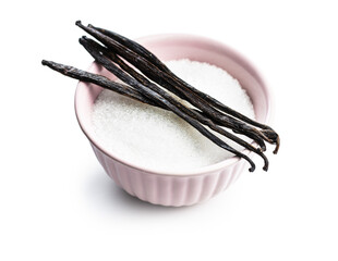 Vanilla pods and sugar in bowl. Sticks of vanilla
