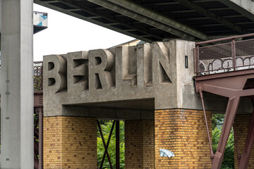 Berlin, Germany - August 7, 2019: Berlin stone name under the iron bridge outside the Deutsches Technikmuseum Berlin, the German Museum of Technology, museum of science and technology