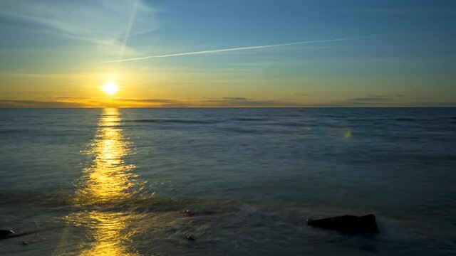 Vibrant spring sundown over dark blue ocean, Time lapse