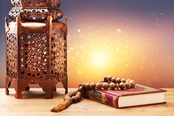 Islamic Holy Book Quran with rosary beads and ornamental arabic lantern