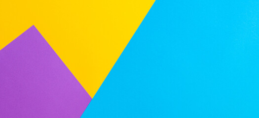 Color papers geometry flat composition background with yellow violet and blue tones