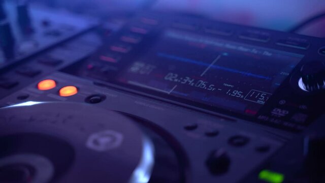 Dj uses Mixing Controller, stroboscopic light and smoke, gimbal shot