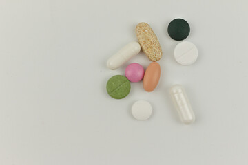 Colorful pills and medication on white background with copy space, health and medication concept