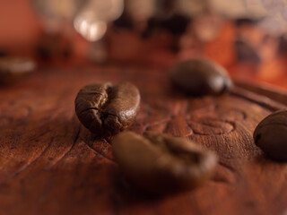 Three coffee beans on carved wooden cup stand macro