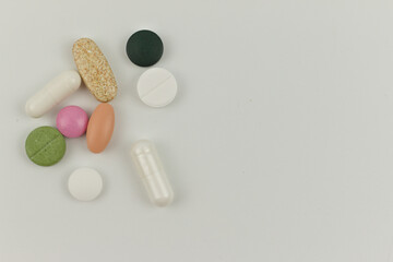 Different colorful pills on white background