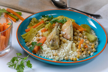Chicken stew with vegetables, hummus and couscous.