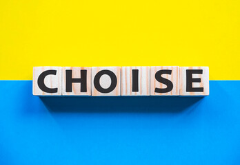 Word CHOISE on wooden cubes with word on beautiful yellow and blue background. Business, media marketing concept. list of items to be discussed at formal meeting
