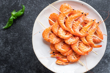 shrimp on skewer prawns kebabs seafood snack trend meal pescetarian diet vegetarian food copy space food background rustic. top view 