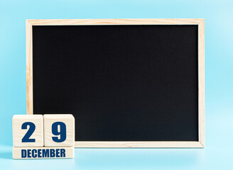 December 29th. Day 29 of month, Cube calendar with date, empty frame on light blue background. Place for your text. Winter month, day of the year concept