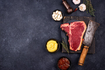 Raw uncooked T-bone steak with spices