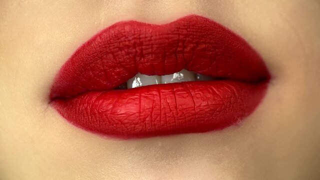 Woman having her lips makeup done. Close-up of a female mouth removing excessive makeup gloss. High quality 4k footage
