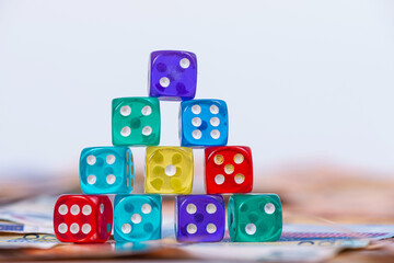 pyramid of dice on the background of euro banknotes, business opportunity and risk concept