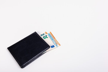 black wallet with euro banknotes isolated on a light background, commerce concept