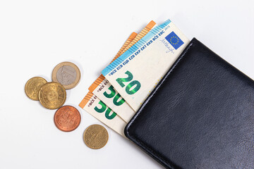black wallet with euro banknotes and coins isolated on a light background, commerce concept