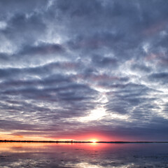 evening sunset over the river freed from ice, ice drift in spring.