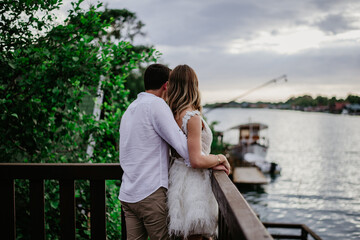 Fototapeta premium couple on the beach on their wedding day bride and groom watching sunset