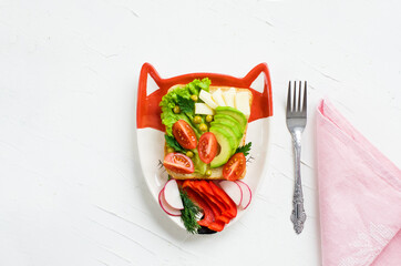 Children's vegetarian sandwich - funny faces. Creative healthy toast. Top view. Healthy vegan food, vegetarian food concept