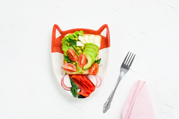Children's vegetarian sandwich - funny faces. Creative healthy toast. Top view. Healthy vegan food, vegetarian food concept