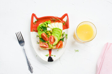 Children's vegetarian sandwich - funny faces. Creative healthy toast. Top view. Healthy vegan food, vegetarian food concept
