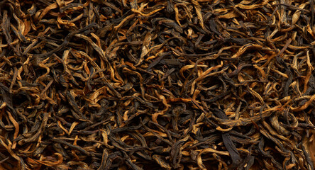 Close-up of dried tea leaves as a background.