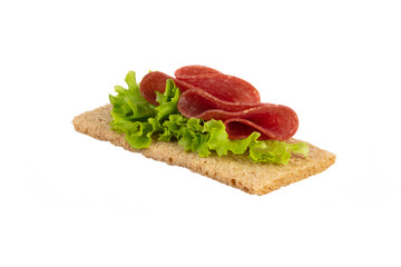 Variety of mini sandwiches with cream cheese, vegetables and salami.