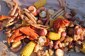 A colorful seafood steamer will be a delicious feast at the beach that includes crab legs, lobster, scallops, shrimp, corn on the cob and potatoes.