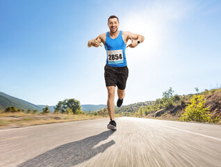 Fit young man running a marathon on an open road and pointing at his number