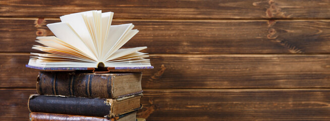 Old books on wooden shelf. Bookshelf history theme grunge background.