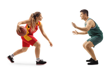 Full length profile shot of a female basketball player and a male basketball player playing a match