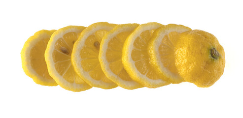 Lemon sliced in wedges and laid out in a row on a white background isolated