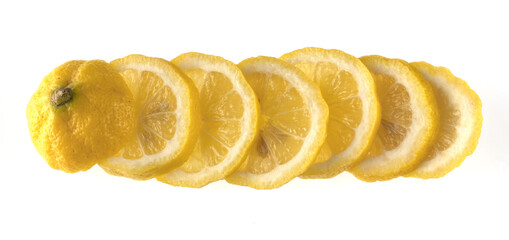 Lemon sliced in wedges and laid out in a row on a white background isolated