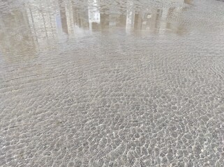 Fototapeta na wymiar water drops on the sand