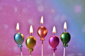 lighted candles greeting, colorful balloons