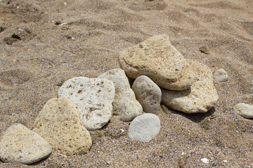 Fototapeta na wymiar Natural stones on summer sandy beach Black sea coast tourism travel concept