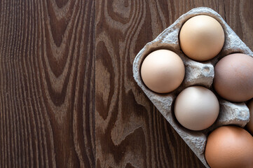 eggs in an egg box on a wooden table. Cooking. Preparing for Easter
